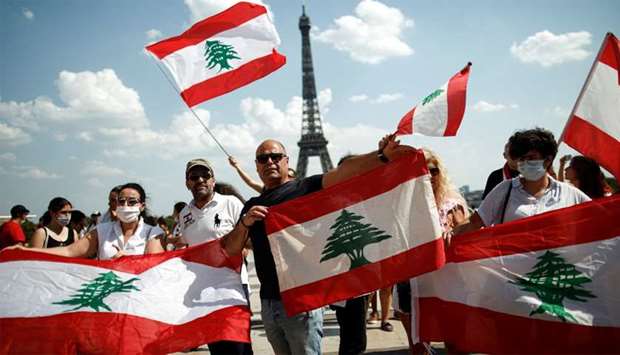 People gather at the Trocadero square near the Eiffel Tower to support the people of Lebanon after Beirut's devastating explosion in Paris