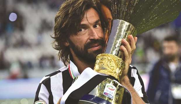 In this file photo taken on May 23, 2015, Juventusu2019 Italian midfielder Andrea Pirlo poses with the Italian Leagueu2019s trophy in Turin. (AFP)