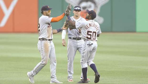 Detroit Tigers left fielder Victor Reyes (22) and centre fielder JaCoby Jones (21) and right fielder Travis Demeritte (50) celebrate in the outfield after defeating the Pittsburgh Pirates at PNC Park. Detroit won 11-5. PICTURE: Charles LeClaire -USA TODAY Sports