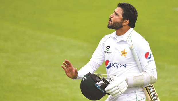 Pakistanu2019s Azhar Ali leaves the field after losing his wicket on the first day of the first Test against England  at Old Trafford in Manchester, United Kingdom, on Wednesday. (AFP)