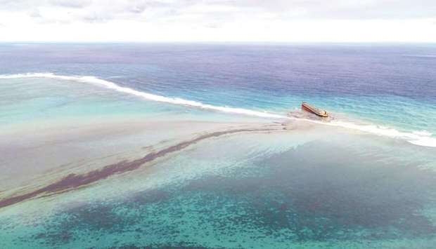 This aerial view shows a large patch of leaked oil and the vessel MV Wakashio (right), belonging to a Japanese company but Panamanian-flagged, that ran aground near Blue Bay Marine Park off the coast of southeast Mauritius.