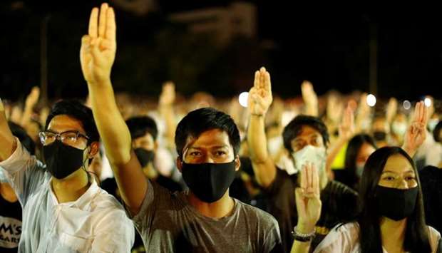 Pro-democracy protesters do a three-fingered salute as they attend a rally to demand the government to resign, to dissolve the parliament and to hold new elections under a revised constitution, at Thammasat University's Rangsit campus outside of Bangkok, Thailand