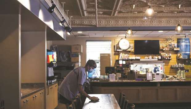 A Sterile X Labs employee disinfects a table at the Dan Lew Exchange restaurant in Mansfield, Ohio. The number of available positions climbed to 5.89mn during the month from a revised 5.37mn in May, according to the Labour Departmentu2019s Job Openings and Labour Turnover Survey, or JOLTS, released yesterday.