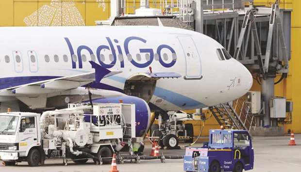 An Indigo aircraft stand at Terminal 3 of Indira Gandhi International Airport in New Delhi. IndiGo plans to raise as much as $534mn by selling new shares after the coronavirus pandemic halted air travel across the world, ravaging the cash flow of carriers.