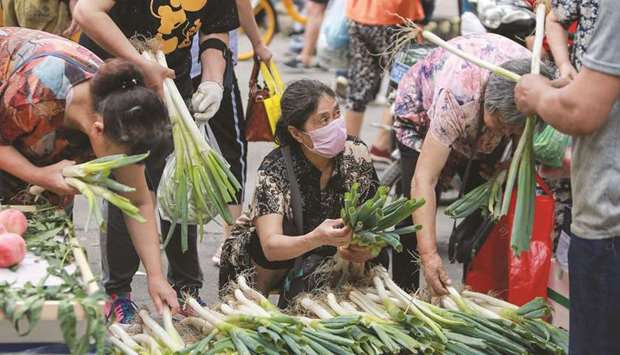 Customers buy vegetables at a market in Shenyang, Chinau2019s northeastern Liaoning province. Chinau2019s consumer inflation edged up in July, official data showed yesterday, partly because of rising food prices from flood-related disruptions and as the country recovers from the coronavirus outbreak.