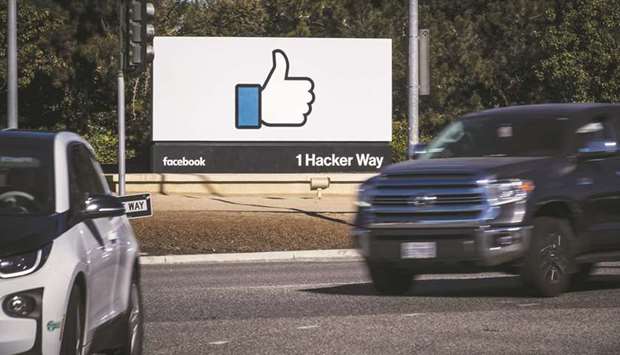 Vehicles pass in front of signage displayed outside Facebook headquarters in Menlo Park, California. Called F2 internally, short for Facebook Financial, the new Facebook team will run all payments projects, including Facebook Pay, the companyu2019s universal payments feature that it plans to build inside all of its apps.