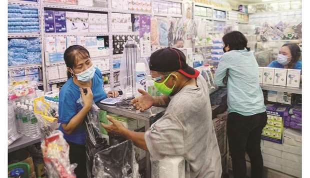 Vendors tend to customers inside a store selling medical and personal protective equipment, amid the coronavirus disease (Covid-19) outbreak, in Manila, yesterday.
