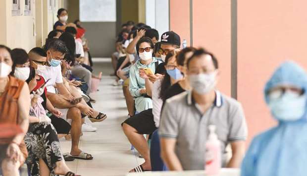 Residents wait to be tested at a makeshift rapid testing centre as Vietnam records a rise in coronavirus cases in Hanoi yesterday. Vietnam has recorded 45 new cases of Covid-19 u2014 its highest single daily tally since the pandemic began u2014 as an outbreak in the resort city of Danang erodes the countryu2019s efforts to stay virus-free.