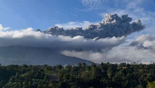 Sinabung volcano spews ash during its second eruption toward dusk as seen from Karo district, North Sumatra