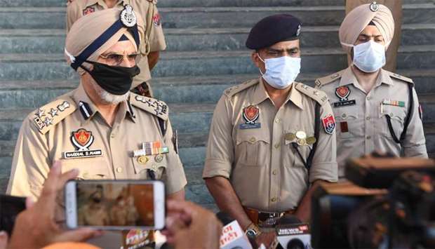 Punjab Director General of Police Hardial Singh Mann (left) and other police officers speak to reporters at Tarn Taran, some 25km from Amritsar, about the liquor tragedy