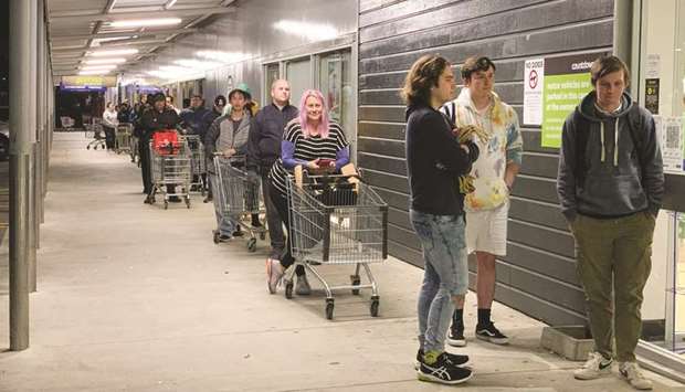Shoppers wait to enter a supermarket in the suburb of Johnsonville in Wellington.  Auckland has been place at level-3 lockdown and the rest of the country has moved to level-2 after a family in South Auckland tested positive for Covid.