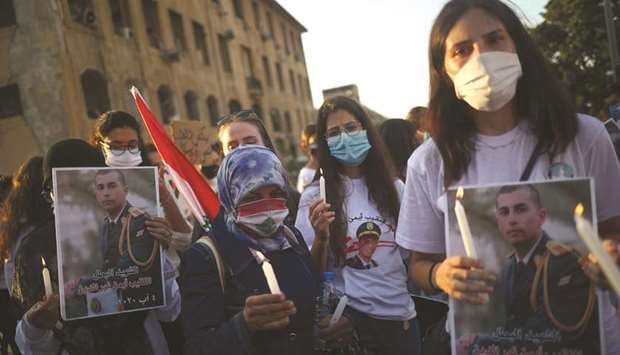 People take part in a vigil for the victims lost in a massive explosion, in Beirut, yesterday.