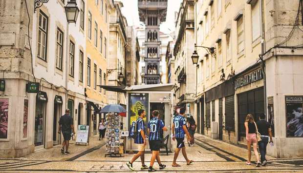 Atalantau2019s supporters walk around downtown Lisbon yesterday ahead of the UEFA Champions League matches. (AFP)