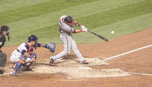Washington Nationals catcher Yan Gomes (10) hits a single during the top of the fifth inning against the New York Mets at Citi Field. PICTURE: Vincent Carchietta-USA TODAY Sports