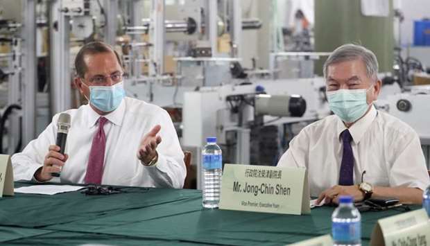 US Secretary of Health and Human Services Alex Azar (L) speaks as Taiwanu2019s Deputy Premier Shen Jong-chin (R) listens during a visit of a mask factory in the Wugu district in New Taipei City