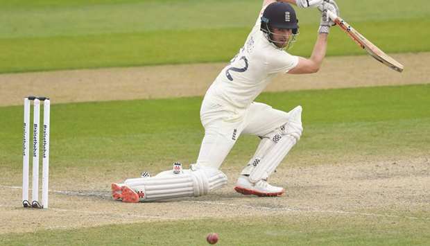 Englandu2019s Dom Sibley hits a boundary during play on the fourth day of the first Test against Pakistan at Old Trafford in Manchester on August 8, 2020. (AFP)