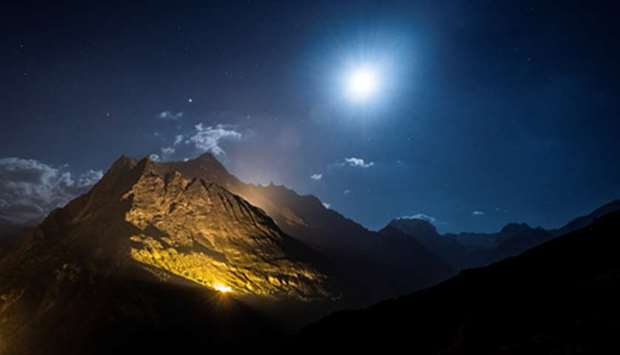 The mountain chains of Veisivi and Dent de Perroc are illuminated on Friday night by 100kg of magnesium powder to celebrate Swiss National Day, in Ferpecle near Evolene in the Val du2019Herens, Switzerland.