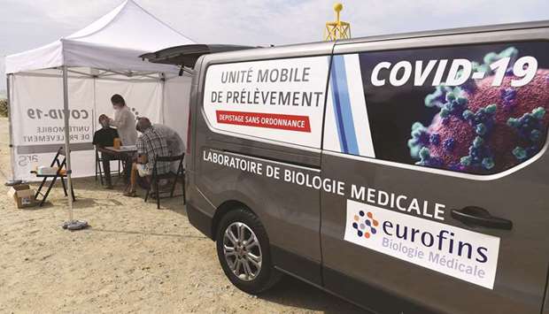 A mobile testing unit for the novel coronavirus (Covid-19) is seen yesterday at the beach of Pentrez in Saint-Nic, western France.