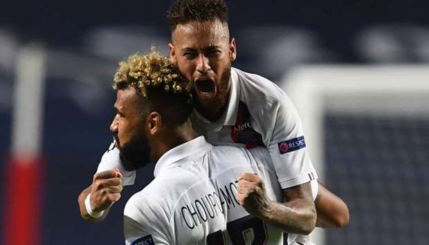 PSG's Eric Maxim Choupo-Moting celebrates with teammate Neymar after scoring a goal.