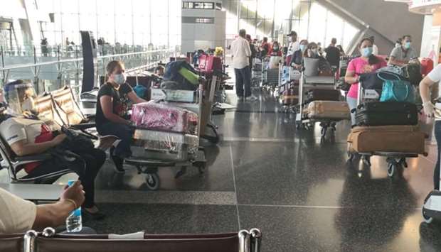 Filipino expatriates wait to board the chartered flight at Doha's Hamad International Airport