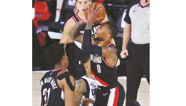 Portland Trail Blazers guard Damian Lillard shoots a three point basket against the Dallas Mavericks during the first half of their NBA game at The Field House in Florida. (USA TODAY Sports)