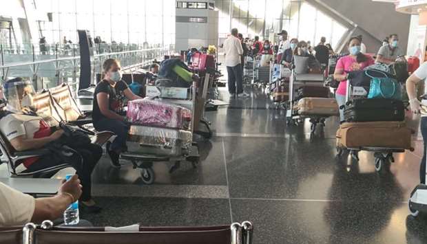 Filipino expatriates wait to board the chartered flight at Dohau2019s Hamad International Airport yesterday.