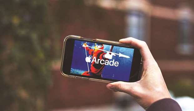Apple Arcade video game subscription service signage is displayed on an iPhone in an arranged photograph taken in the Queens Borough of New York. The new bundles are designed to encourage customers to subscribe to more Apple services, which will generate more recurring revenue.