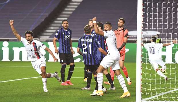 Paris Saint-Germainu2019s Marquinhos (left) celebrates after scoring against Atalanta during the UEFA Champions League quarter-final in Lisbon on Wednesday night. (AFP)