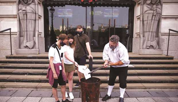 Students burn their A-Level results at London Dungeons, in London yesterday.