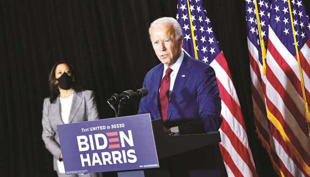 Harris listens as Biden speaks following a coronavirus briefing with health experts at the Hotel DuPont in Wilmington, Delaware.