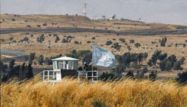 A UN peacekeeper stands on duty at an outpost of the United Nations Disengagement Observer Force (UNDOF) buffer zone between Syria and the Israeli-annexed Golan Heights on August 11
