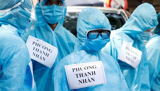 Medical healthcare workers wearing protective suits are seen at a testing center for coronavirus disease in Hanoi, Vietnam