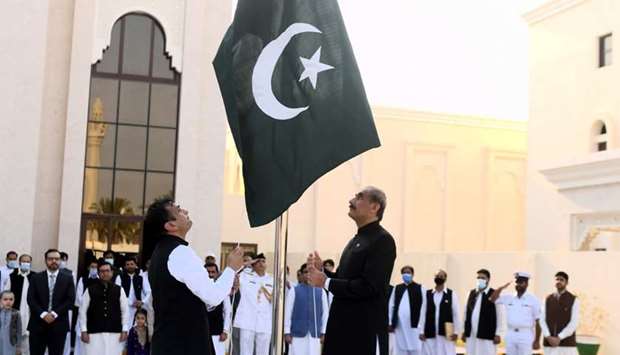 Pakistan ambassador Syed Ahsan Raza, right, hosting the national flag to mark the Independence Day of Pakistan Friday on the new embassy premises. PICTURE: Shemeer Rasheed.