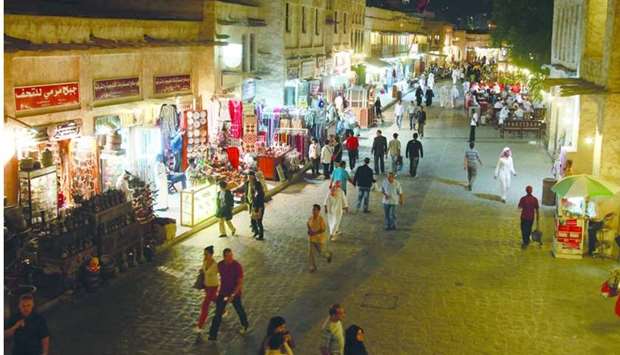 Visitors walk past stores at Souq Waqif in Doha (file). The country's CPI inflation was down 0.23% month-on-month in the review period, the figures released by the PSA show.