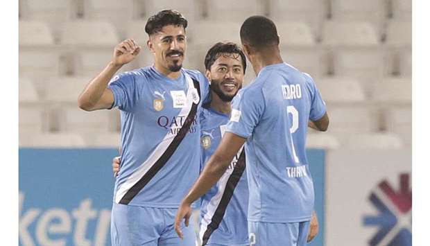 Al Saddu2019s Baghdad Bounedjah (left) celebrates with teammates after scoring against Qatar SC in the QNB Stars League yesterday.