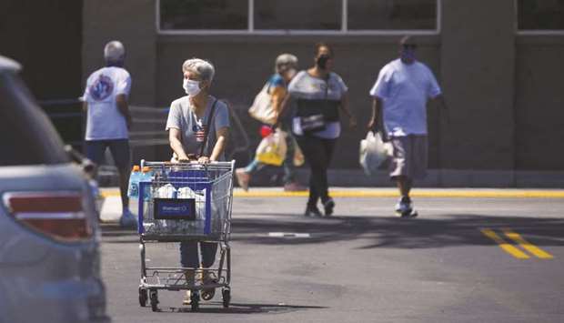 Shoppers leave a Walmart store in Lakewood, California. Retail sales have been rebounding in the US as businesses resumed operations after being shuttered in mid-March in an effort to slow the spread of Covid-19.
