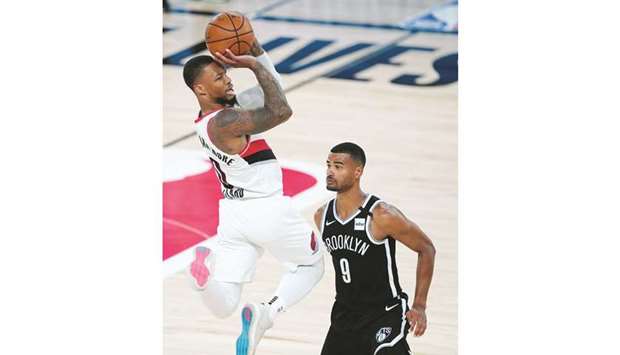 Portland Trail Blazersu2019 Damian Lillard (left) goes up with the ball against Brooklyn Netsu2019 Timothe Luwawu-Cabarrot during the first half of their NBA game at Lake Buena Vista, Florida. (USA TODAY Sports)