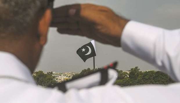 A Pakistan Navy officer salutes at the mausoleum of founder Mohamed Ali Jinnah during the Independence Day celebrations in Karachi.