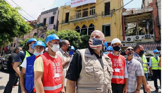 United States Agency for International Development (USAID) Acting Administrator, John Barsa, inspects the aftermath of a massive explosion, as he walks along the street, in Beirut, Lebanon August 11