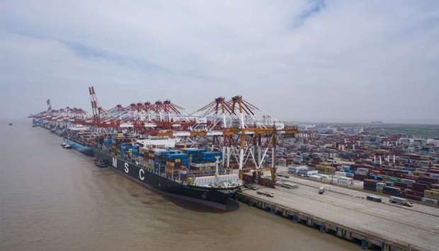 Vessels sit loaded with shipping containers at the Yangshan Deepwater Port in this aerial photograph taken in Shanghai. China's imports of US farm and manufactured goods, energy and services are well behind the pace needed to meet a first-year target increase of $77bn over 2017 purchases.