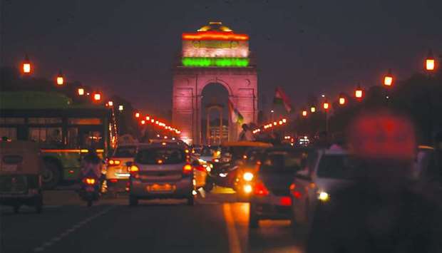 A general view shows traffic in front of the illuminated India Gate on the occasion of the India's 74th Independence Day in New Delhi