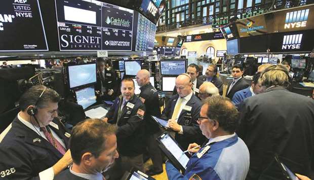 Traders work on the floor at the New York Stock Exchange (file). Investors are girding their portfolios for market moves ahead of the US presidential vote, as election season kicks into higher gear with the Democratic National Convention in the coming week.