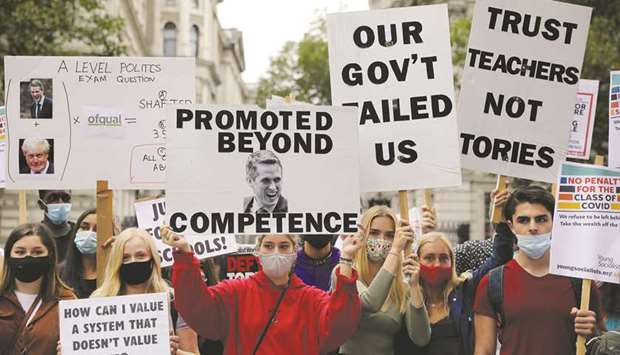 Students hold placards during their protest yesterday at Downing Street in London.