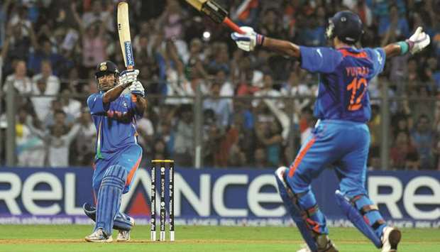 In this April 2, 2011, picture, Indiau2019s Mahendra Singh Dhoni (left) hits a six against Sri Lanka to win the 2011 ICC World Cup final at the Wankhede Stadium in Mumbai, India. (AFP/Getty)