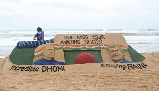 Indian artist Sudarsan Pattnaik gives final touches to his sand sculpture depicting Indian cricketers MS Dhoni and Suresh Raina, who both announced retirement from international cricket on Saturday, in Puri, India. (AFP)Hinterland to centrestage, Dhoni ends journey with enigma intact