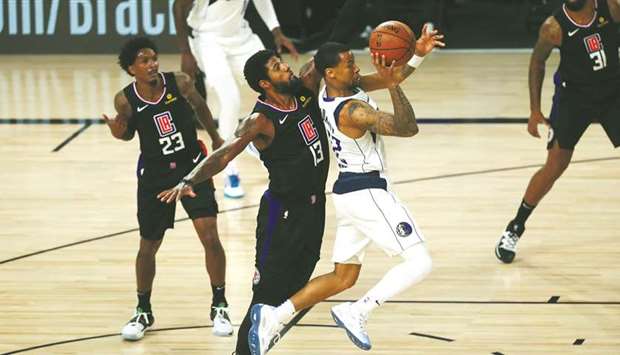 LA Clippers guard Paul George (13) blocks Dallas Mavericks guard Trey Burke (32) in the first half in game one of the first round of the 2020 NBA Playoffs at AdventHealth Arena on Monday. PICTURE: Kim Klement-USA TODAY Sports