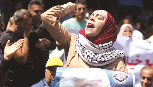 A Palestinian woman shouts slogans during a protest against the United Arab Emiratesu2019 deal with Israel to normalise relations, in Gaza City yesterday.