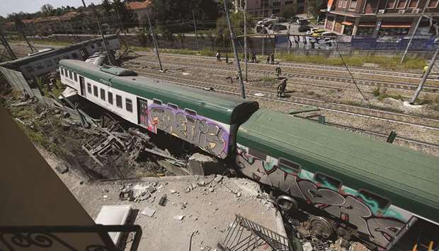 Train carriages are seen at the site where it derailed in Carnate, in northern Italy.
