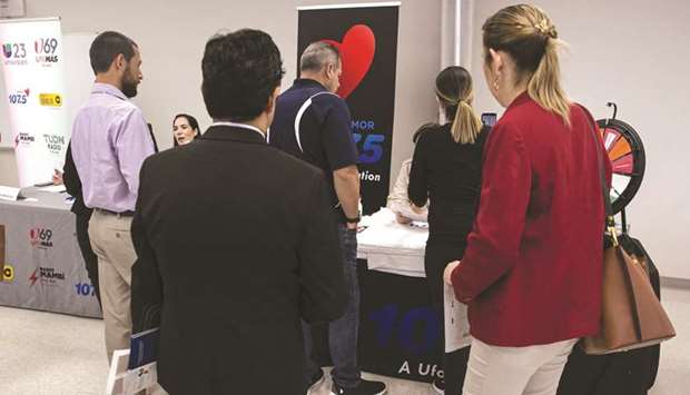 Job seekers stand in line to speak with company representatives during a job fair in Miami. Initial jobless claims in regular state programs rose by 135,000 to more than 1.1mn in the week ended August15, Labour Department data showed yesterday.