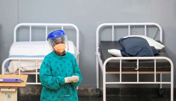 A health worker walks between beds at a temporary field hospital set up by Medecins Sans Frontieres (MSF) during the coronavirus disease outbreak in Khayelitsha township near Cape Town, South Africa, July 21